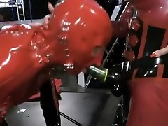 Two latex mistresses peg slave hard with strapon .