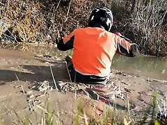 forest ranger walks in deep mud with his clothes on