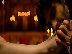 Paz Vega seen from behind in a campfire-lit cave as she