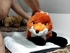 pissing on a fox plushie