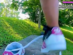 Girl in red Adidas Superstars does shoeplay, dipping fishnet socks