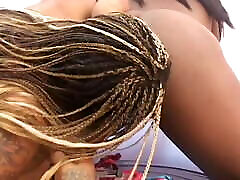 Young ebony sucks a dildo while titty smacks lesbian lover fucks her