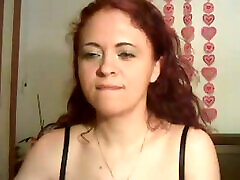 Feisty redhead babe poses for camera wearing black bra and tiny thongs